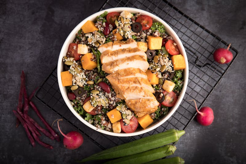 Grilled chicken salad bowl with fresh greens